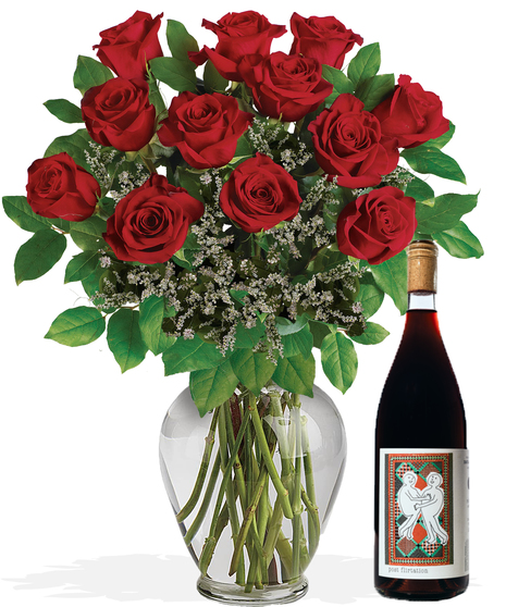 One dozen long stemmed red roses in a clear glass vase.