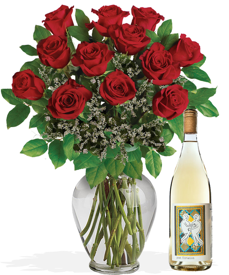 One dozen long stemmed red roses in a clear glass vase.
