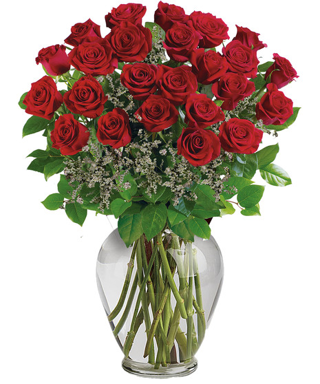 One dozen long stemmed red roses in a clear glass vase.