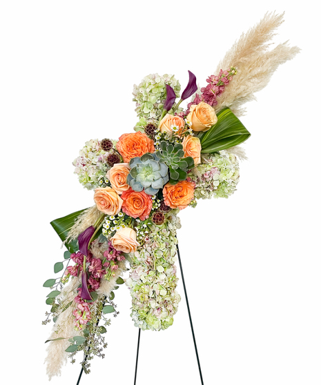 Sympathy wreath of pastel pink, peach and purple flowers