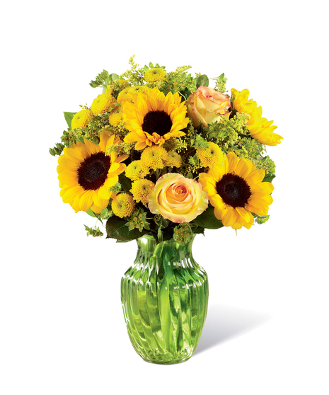Sunflowers, yellow roses and other yellow flowers in a clear glass vase.