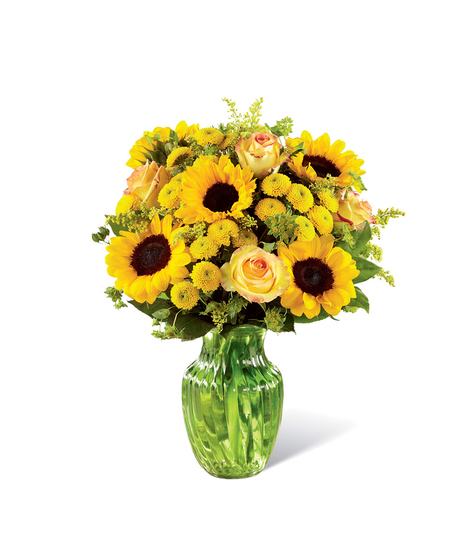 Sunflowers, yellow roses and other yellow flowers in a clear glass vase.
