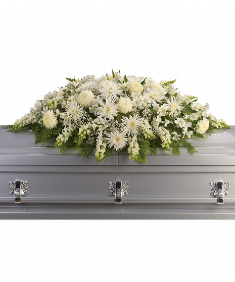All-white casket spray accented with greenery.