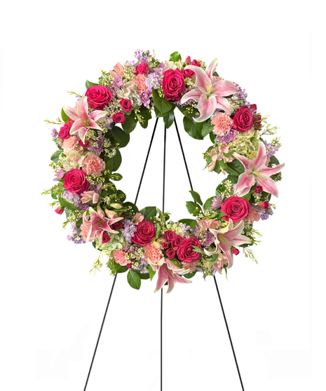 Sympathy wreath of pastel pink, peach and purple flowers