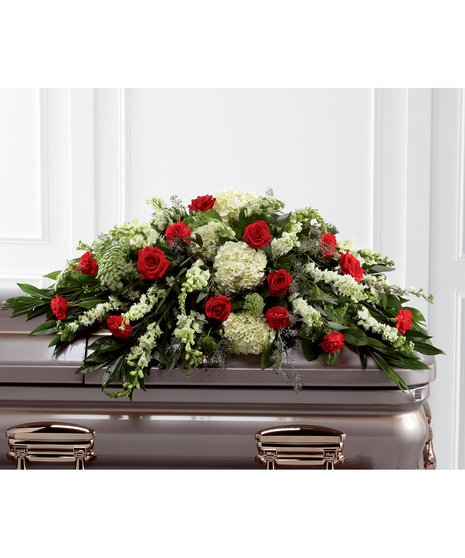 Casket spray of red roses and carnations, white hydrangea, larkspur, snapdragons and more. 