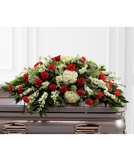 Casket spray of red roses and carnations, white hydrangea, larkspur, snapdragons and more. 