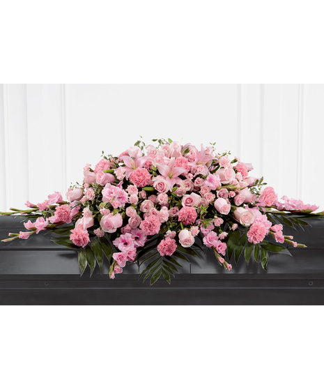 Casket spray of pink roses, spray roses, carnations, Asiatic lilies and more with greenery. 