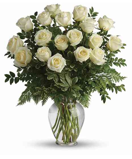 White rose bouqut in a clear glass vase. 
