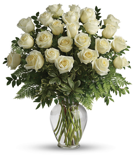 White rose bouqut in a clear glass vase. 